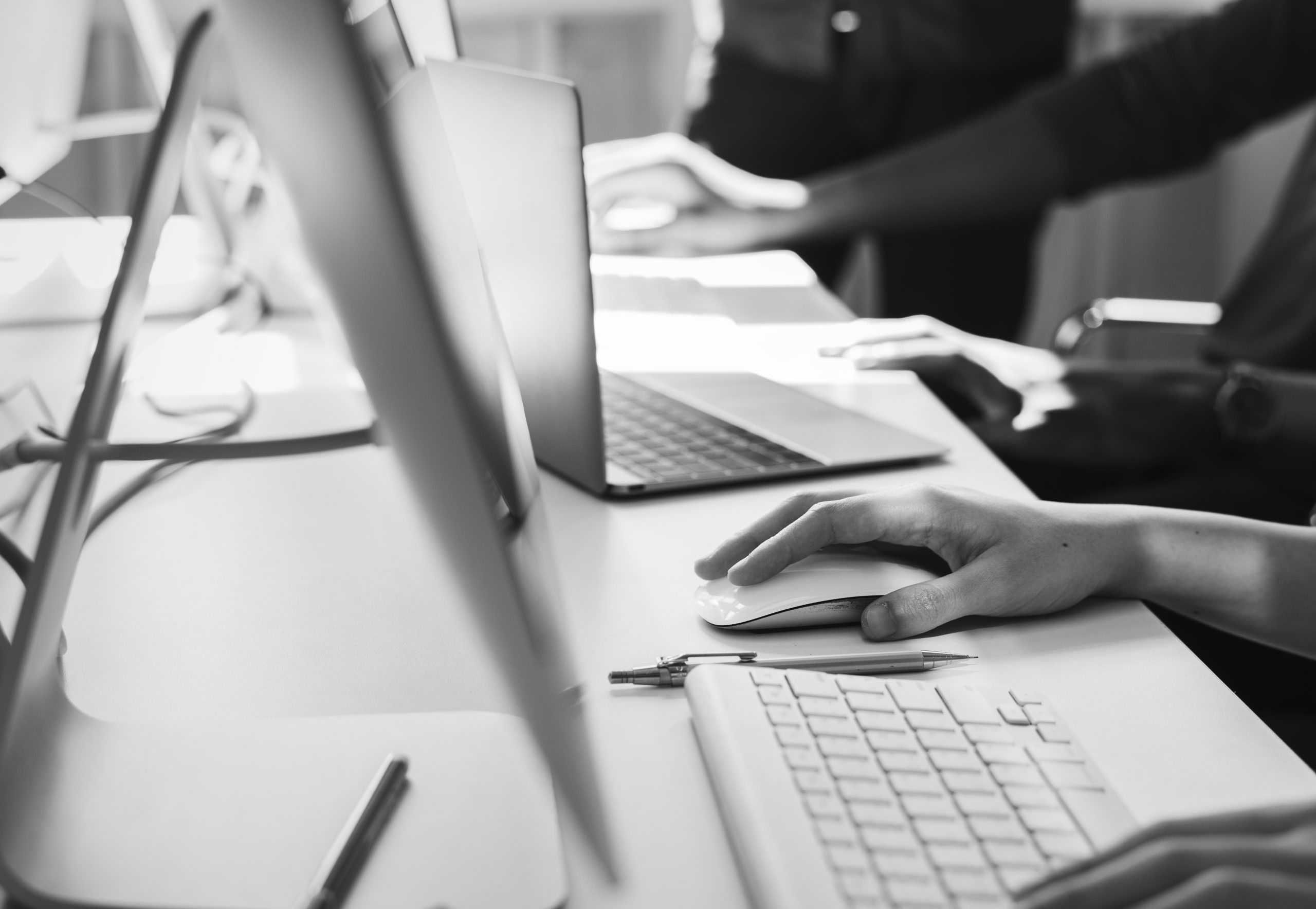 Close up of people's hands working on computers
